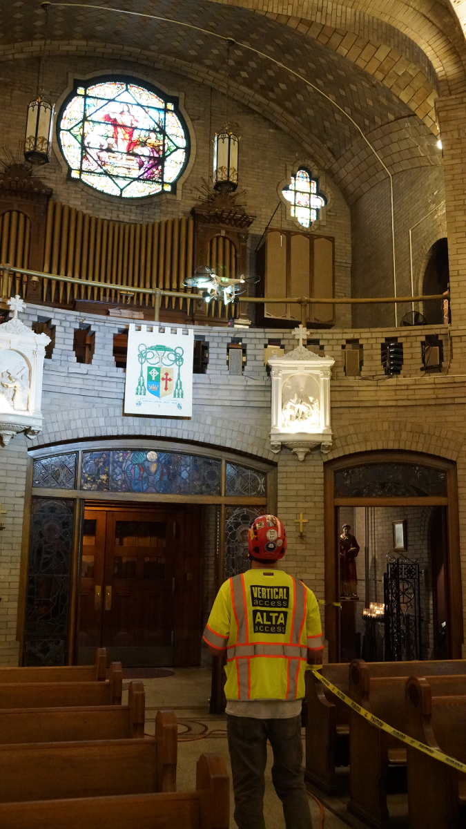 Technicians from Vertical Access send up a drone to scan the dome and ceiling of the choir loft. 
