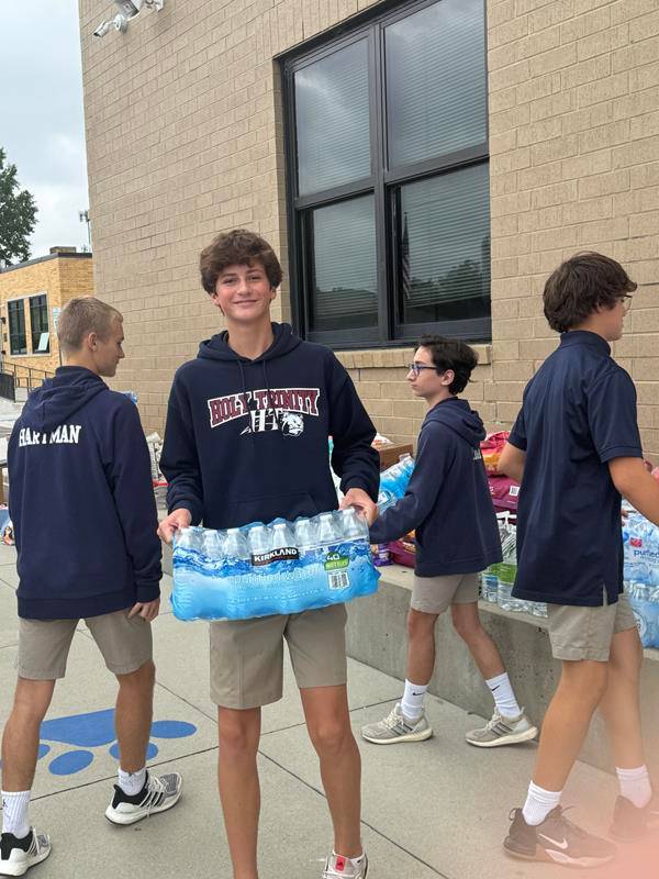 Holy Trinity Middle School students load water and supplies to be taken to western North Carolina.