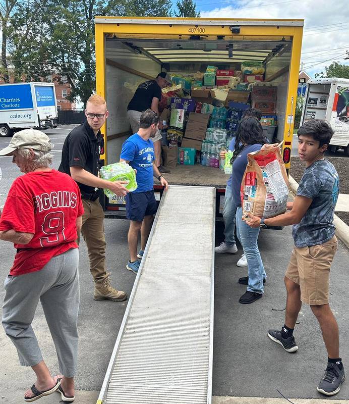 Volunteers unload supplies on Oct. 3 at Immaculata Catholic School.