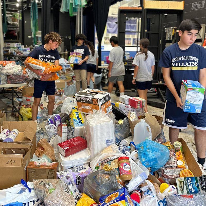Bishop McGuinness High School students organize supplies.