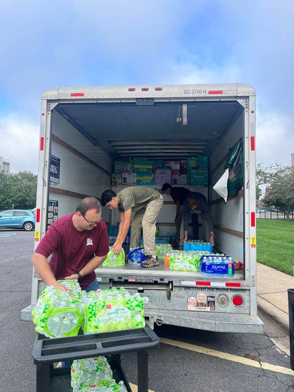 Seminarians load a truck full of supplies donated at the Diocese of Charlotte’s Pastoral Center.