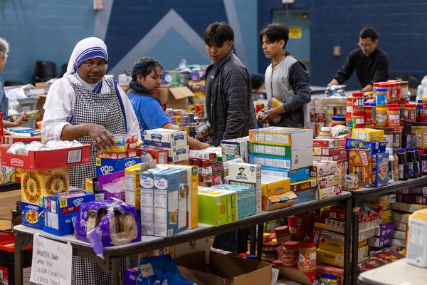 Incoming food and supplies are quickly sorted so they can be handed out to needy families as soon as possible. (Gabriel Swinney)