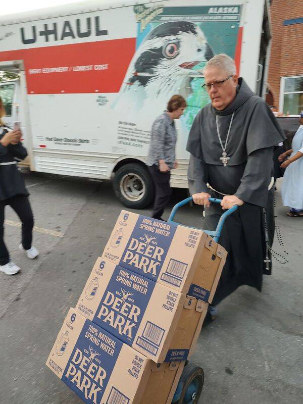 Bishop Martin unloading supplies