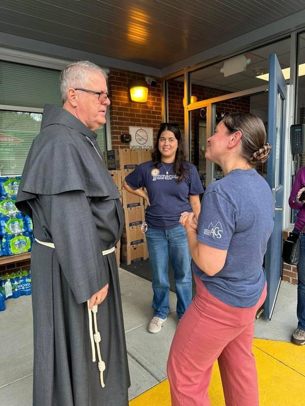 Bishop Martin talks with Immaculata Principal Margaret Beale and Asheville Catholic Principal Melissa Stuart.