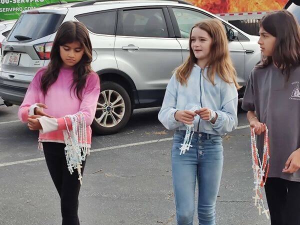 ICS students are also handing out rosaries to people who want them.