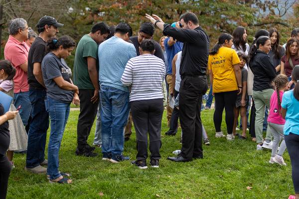 Father Miguel Sanchez, Bishop Martin's priest-secretary, also met with and blessed parishioners. (Gabriel Swinney)
