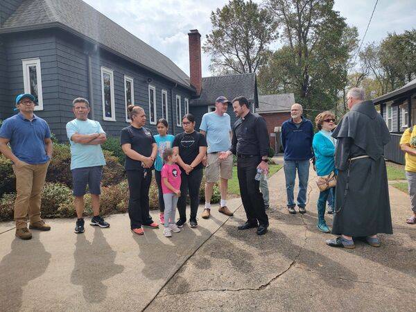 People greet Bishop Michael Martin outside St. Margaret Mary Church in Swannanoa on Friday.
