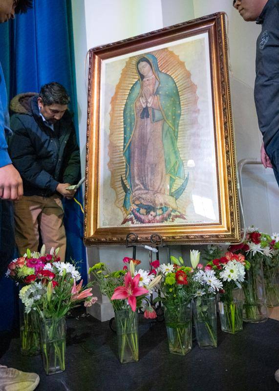 In the gym, students paid tribute to Our Lady with flowers.