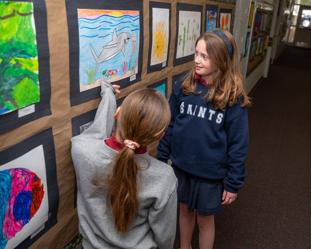 St. Ann School’s parents were treated to works of arts this morning after Mass. The students had an opportunity to give their parents a personal tour and show off their art inspired by St. Francis that lined the first-floor hallway.
