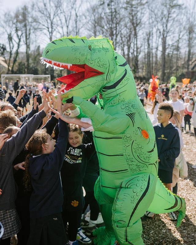 Superintendent of Schools Dr. Gregory Monroe dawns a dino costume at St. Gabriel School in Charlotte during Catholic Schools Week.
