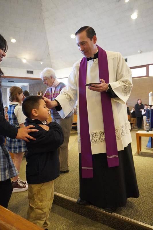 Students at Asheville Catholic School receive ashes for the start of Lent. 