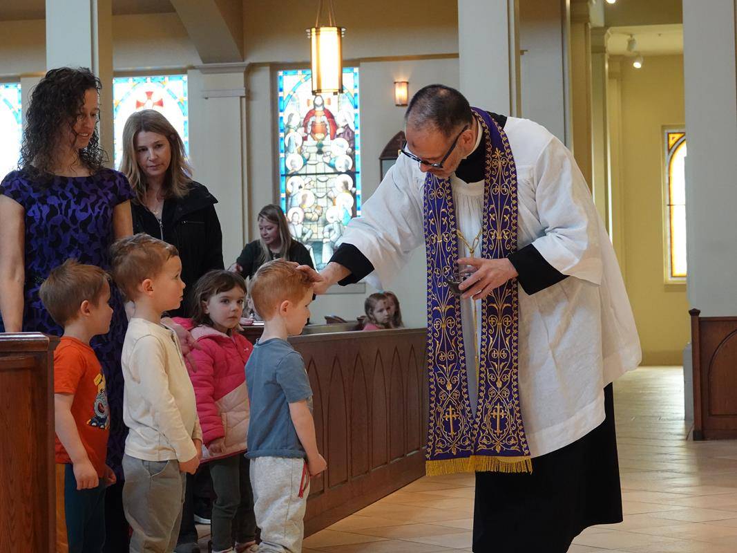 Father John Putnam celebrated a Liturgy of the Word and Ashes service for St. Mark School preschool students.