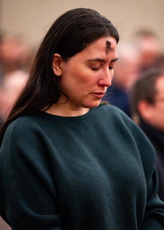 People receive ashes for the start of Lent at St. Peter Church in Charlotte. 