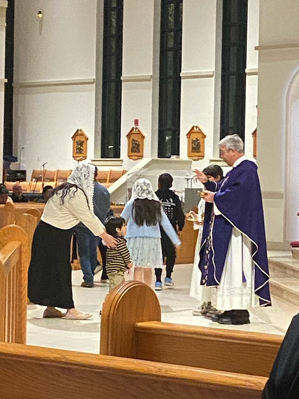 People receive ashes for the start of Lent at St. Therese Church in Mooresville.