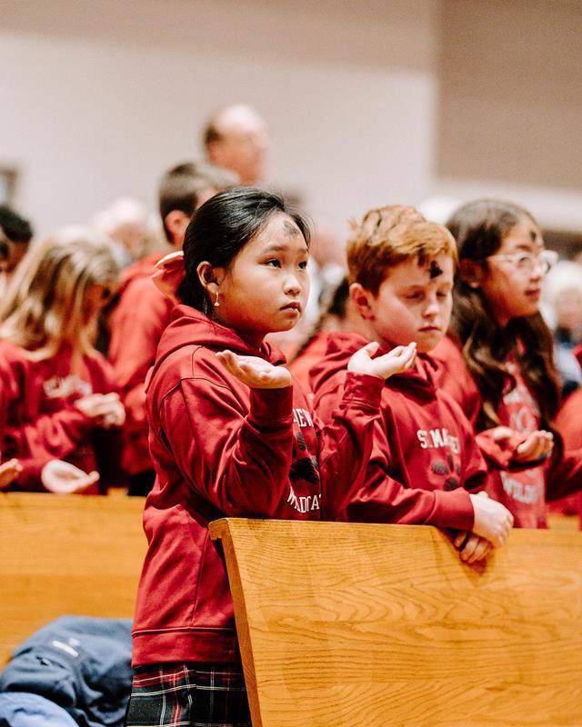 Students at St. Matthew School in Charlotte receive ashes for the start of Lent. 