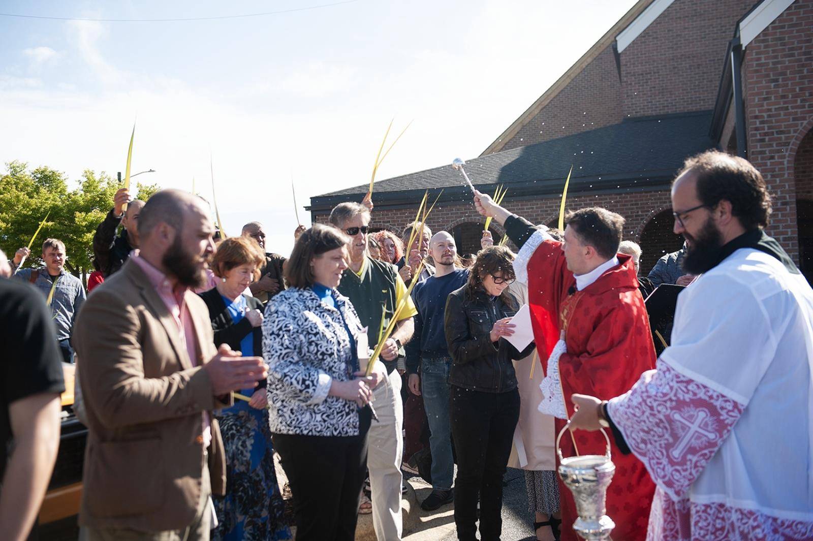 Immaculate Conception Parish in Hendersonville started Holy Week by holding palms in the air as Fathers Andres Felipe Gutierrez and David O'Connor blessed them. (Photos provided)