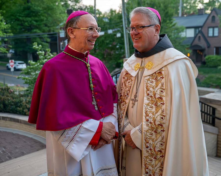 Bishop Emeritus Peter Jugis (left) and Bishop Michael Martin share a few words outside St. Patrick Cathedral in Charlotte after leading the people of the diocese in prayer for the late pope. The prayer service marked the first time both bishops were toget