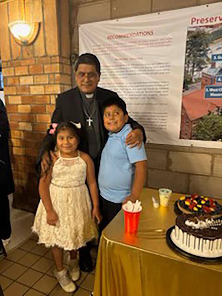 Parishioners at St. Lawrence Basilica say goodbye to Father Nohé Torres, who is leaving to become pastor at Holy Infant Parish in Reidsville, with a celebration featuring gifts and a cake. 
