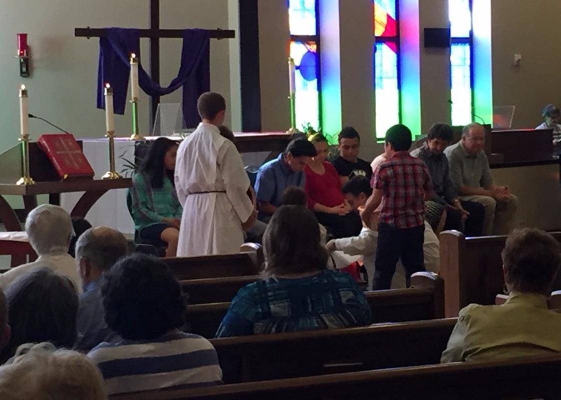 Father Alex Ayala, Pastor at the Immaculate Heart of Mary Mission, washes the feet of parishioners during Holy Thursday Mass recreating the tradition of service begun by Jesus at the Last Supper. (By Craig Allen)