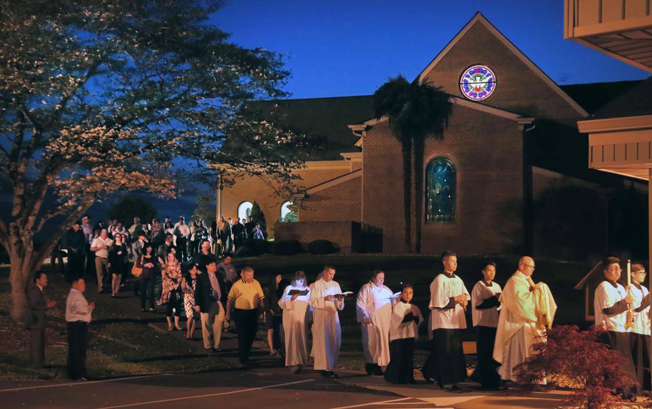 SHELBY — Father Michael Kottar followed by the congregation of St. Mary Help of Christians taking the Blessed Sacrament to the altar of repose. (by Giuliana Polinari Riley)