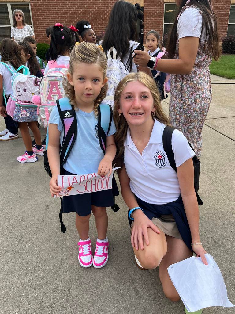 At Sacred Heart School in Salisbury, kindergarten students walk hand-in-hand into school with their 8th grade buddies. 