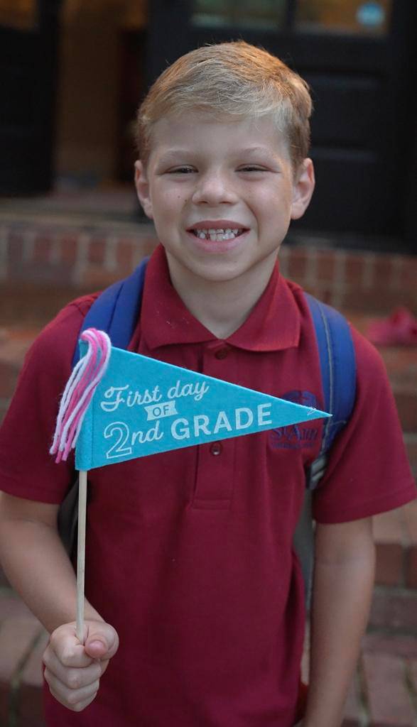 Smiles and waves from St. Patrick School in Charlotte students excited for the school year to start. 