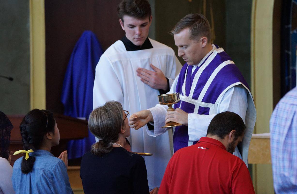 Father Jason Barone led the solemn liturgy and was joined by Father Joseph Matlak, the chaplain for the Holy Trinity Middle School to chant the Passio Domini (Passion of Our Lord Jesus Christ) in Latin.  (By John Cosmas)