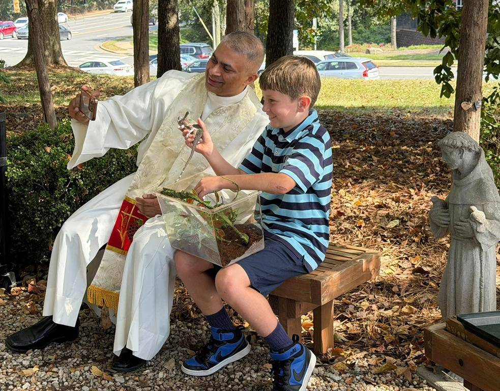 Father Patrick Cahill and Father Binoy Davis blessed cats, dogs, birds and even some reptile friends for the Feast of St. Francis of Assisi at St. Matthew Church in Charlotte. 