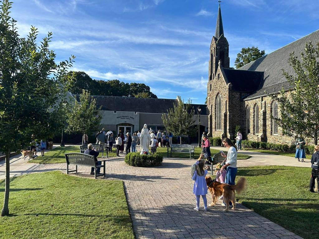 Deacon Ralph at St. Leo the Great Church in Winston-Salem blesses animals on Oct. 4 outside the church.