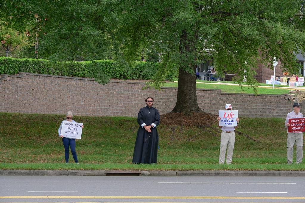 Faithful gathered in south Charlotte with Father Cahill, FatherKramer and Deacon Joe Becker to pray for life near St. Matthew Church. 