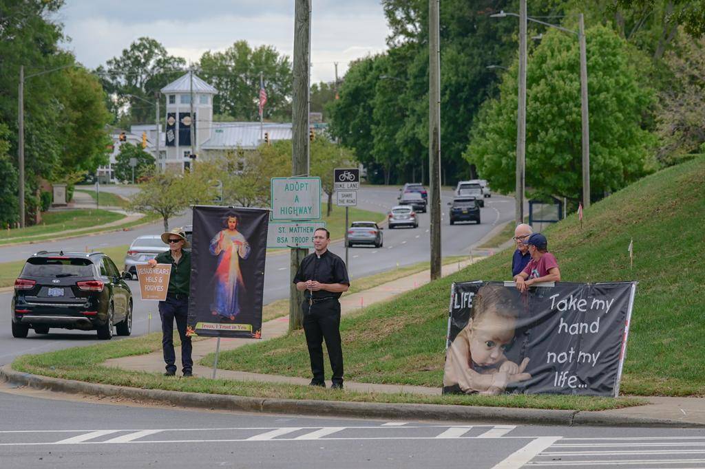 Faithful gathered in south Charlotte with Father Cahill, FatherKramer and Deacon Joe Becker to pray for life near St. Matthew Church. 
