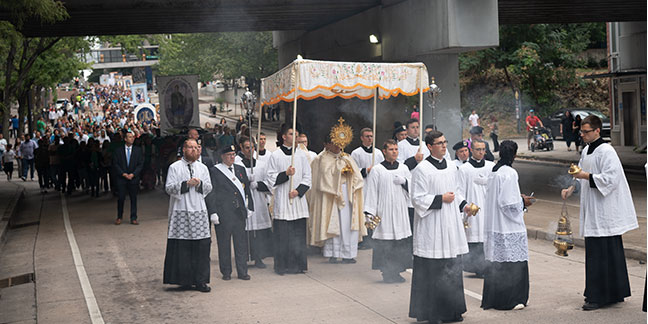 Faithful celebrate Jesus in the Eucharist in joyous procession