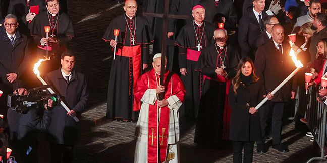 Pope carries the cross, leading thousands in Good Friday prayer for suffering world
